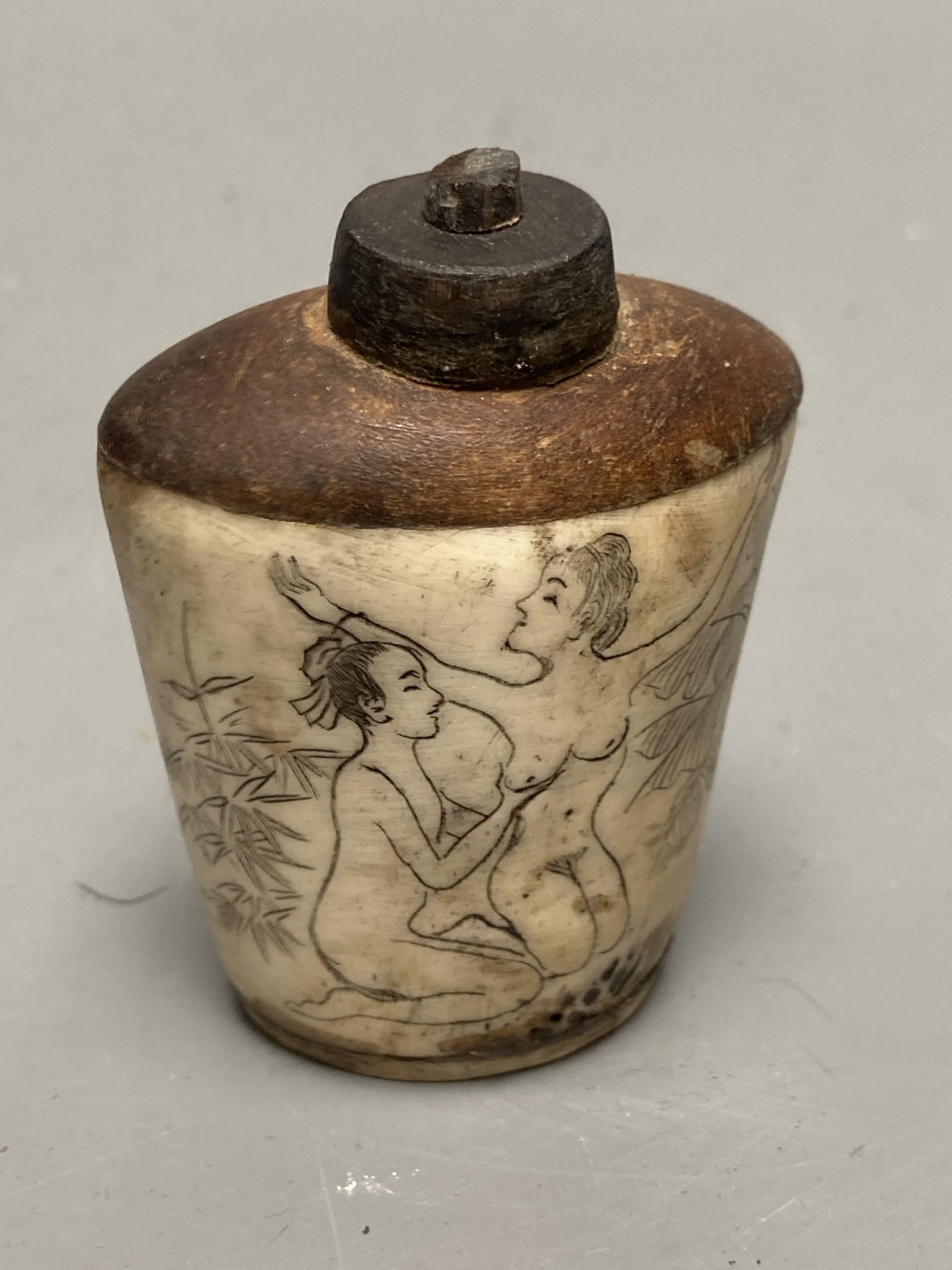 Two Chinese snuff bottles, one with erotic carving, tallest 7cm